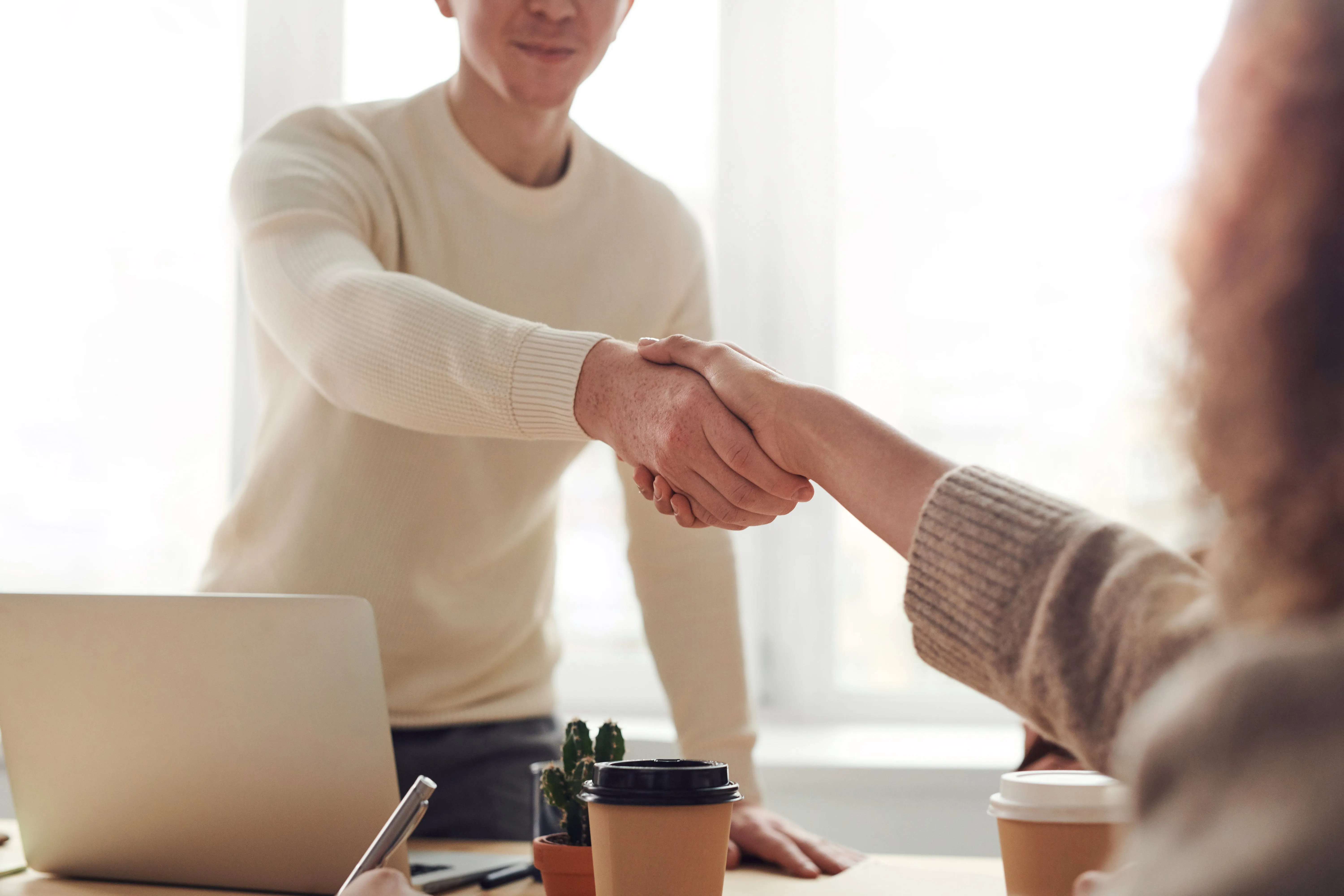IT leader meeting with a New Client Handshake symbolizing tech partnership