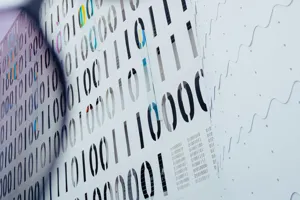 An abstract image that shows zeros and ones with some partially through corrective lenses to relfect our focus on data support service offerings.